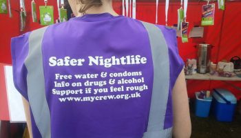 Crew worker wearing a Safer Nightlife bib Crew worker wearing a Safer Nightlife bib